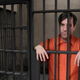 Inmate #29384 considers counting the bars again.